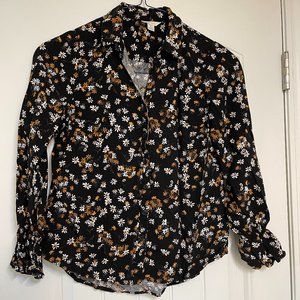 Cute long sleeve, black, button down shirt with golden and cream flowers.